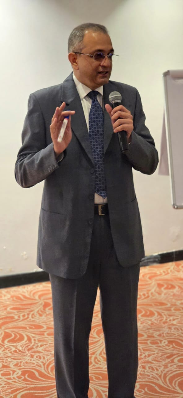 Gopal Kamath leading a training session with a microphone